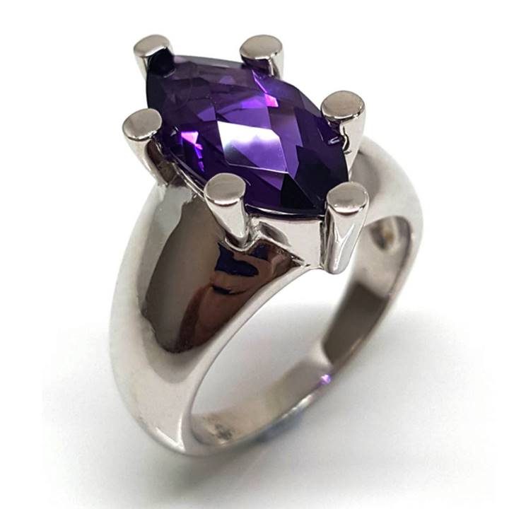 Like to make a cocktail or dinner party statement? Look no further than this delightfully bold modernist Amethyst gemstone and sterling silver ring! Featuring a central solitaire marquise shape purple amethyst gem of approx. 18mm top width and approx. 3.6 ct. t.w. , six prong set into a chunky 10mm wide tapered 925 sterling silver band. The band tapers to approx. 3mm at the base. This December birthstone and the 4th anniversary gem tips the scales at approx. 8.5 grams. The ring is rhodium plated to provide shine and durability. Perfect for us bigger girls with fatter fingers, not every girl can wear this ring - but maybe you can!