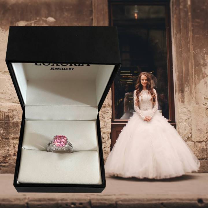 Faux pink diamond ring next to a bride