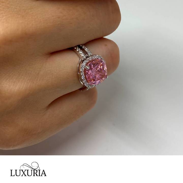 Pink cubic zirconia engagement ring on hand